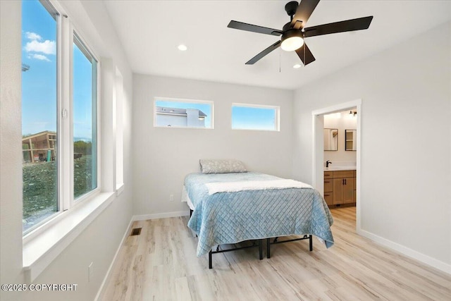 bedroom featuring baseboards, ceiling fan, light wood-type flooring, and visible vents
