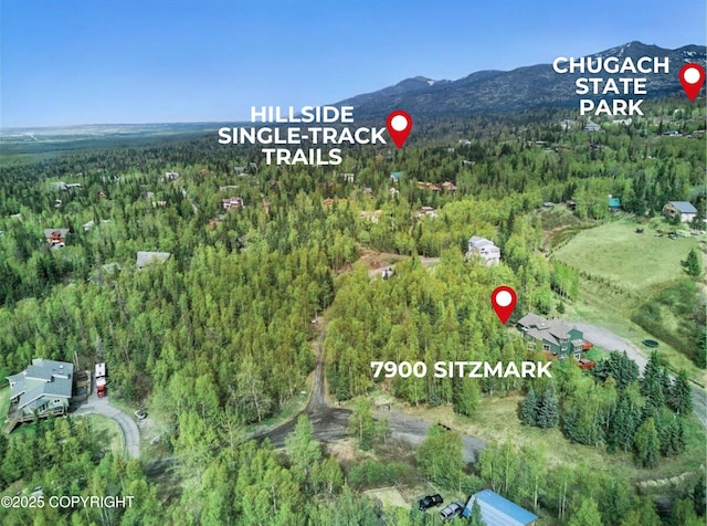 7900 Sitzmark Cir, Anchorage, AK 99507 - aerial view of property and surrounding area featuring a forest and a mountainous background