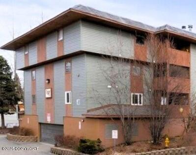 8515 Jewel Lake Rd # 25, Anchorage, AK 99502 - view of building exterior featuring an attached garage