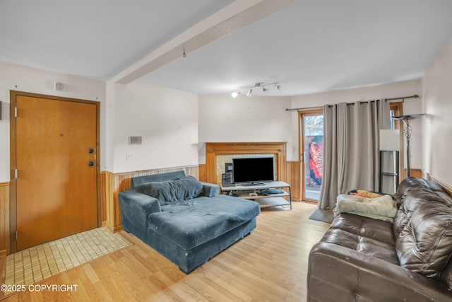 8515 Jewel Lake Rd # 25, Anchorage, AK 99502 - living area featuring wood finished floors, wainscoting, wood walls, and a fireplace