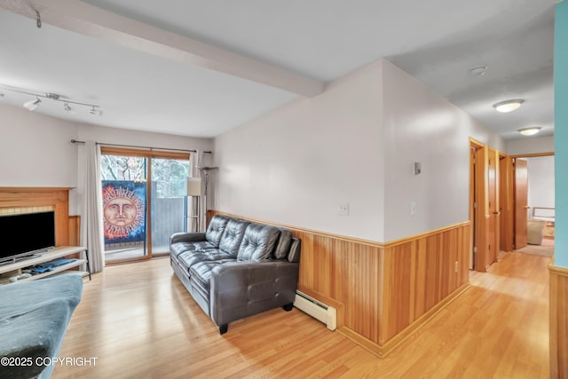 8515 Jewel Lake Rd # 25, Anchorage, AK 99502 - living room with a baseboard radiator, light wood-style floors, wainscoting, and wood walls