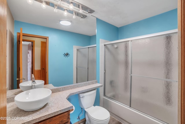 8515 Jewel Lake Rd # 25, Anchorage, AK 99502 - bathroom featuring vanity, toilet, and shower / bath combination with glass door
