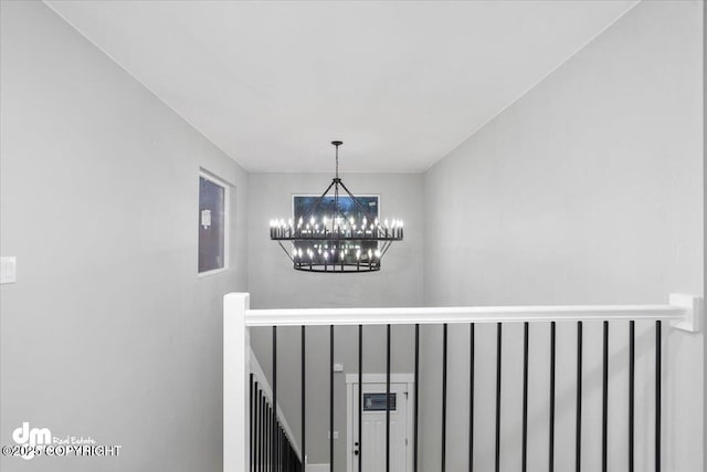 stairs with a chandelier