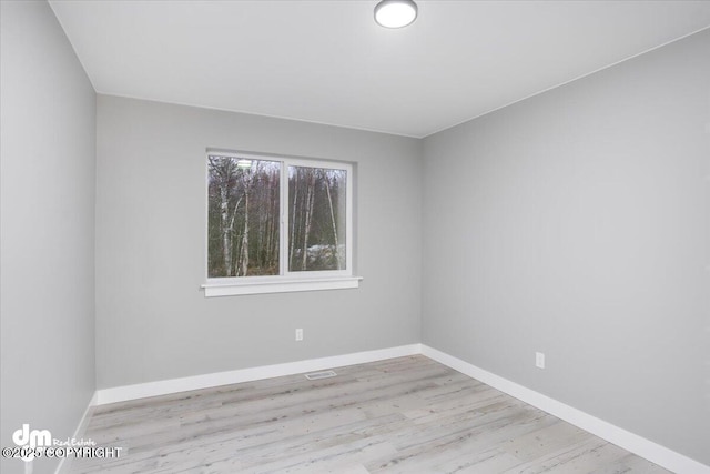 empty room with wood finished floors and baseboards