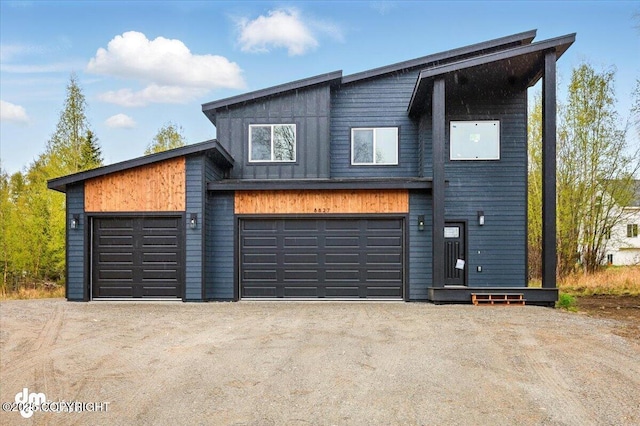 view of front of house featuring a garage and dirt driveway