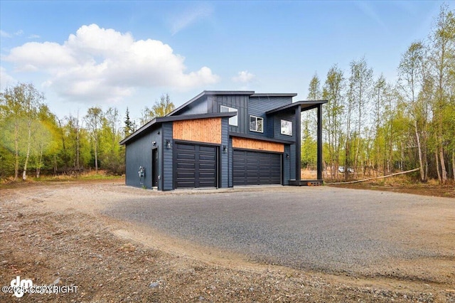garage featuring asphalt driveway