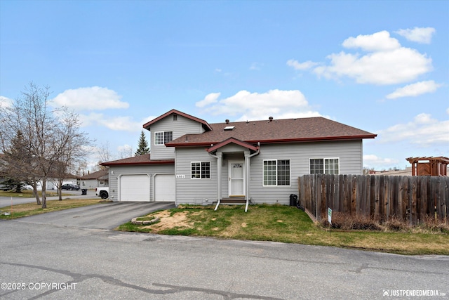 6801 E Tudor Rd, Anchorage, AK 99507 - view of front of home with fence, a shingled roof, aphalt driveway, a garage, and a front yard