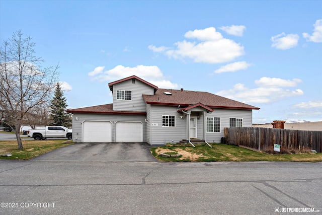 6801 E Tudor Rd, Anchorage, AK 99507 - traditional-style house with a garage, aphalt driveway, fence, a front yard, and roof with shingles