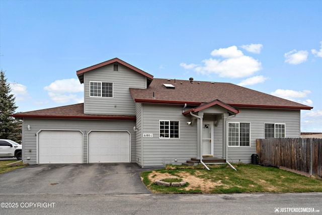 6801 E Tudor Rd, Anchorage, AK 99507 - view of front of property featuring driveway, a garage, fence, a shingled roof, and entry steps