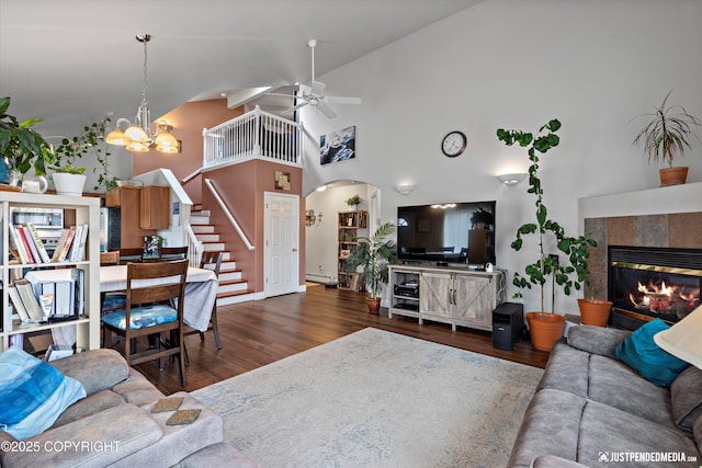 6801 E Tudor Rd, Anchorage, AK 99507 - living area featuring a fireplace, wood finished floors, stairway, and ceiling fan with notable chandelier