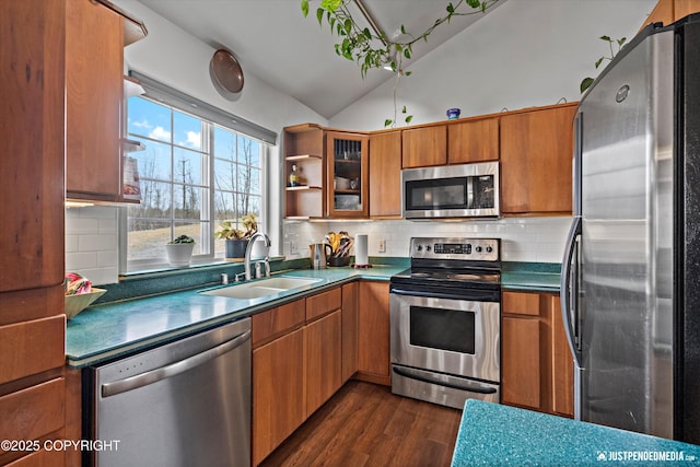 6801 E Tudor Rd, Anchorage, AK 99507 - kitchen with brown cabinets, stainless steel appliances, dark wood finished floors, and a sink
