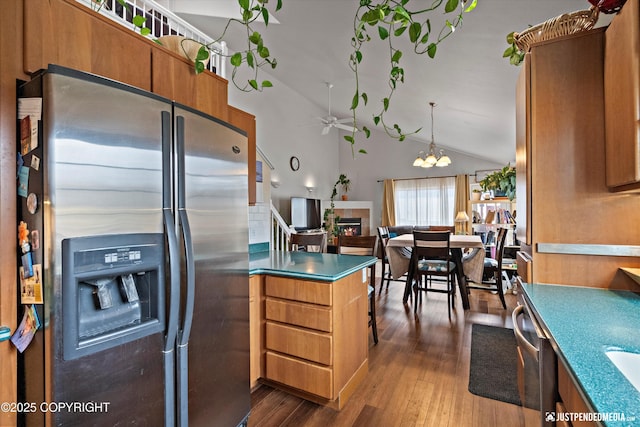 6801 E Tudor Rd, Anchorage, AK 99507 - kitchen with a peninsula, ceiling fan with notable chandelier, brown cabinetry, stainless steel fridge with ice dispenser, and dark wood finished floors