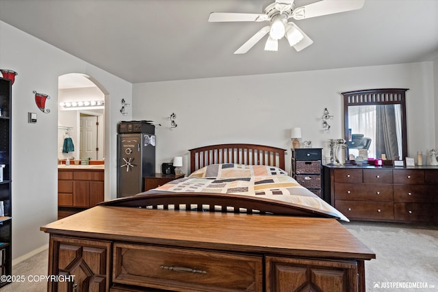 6801 E Tudor Rd, Anchorage, AK 99507 - bedroom featuring arched walkways, ceiling fan, light carpet, and ensuite bath