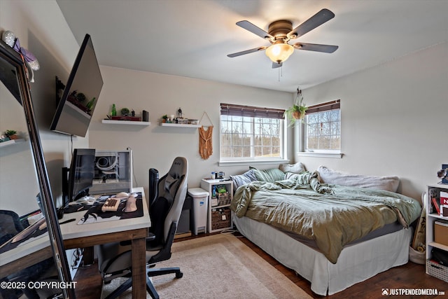 6801 E Tudor Rd, Anchorage, AK 99507 - bedroom featuring a ceiling fan and wood finished floors