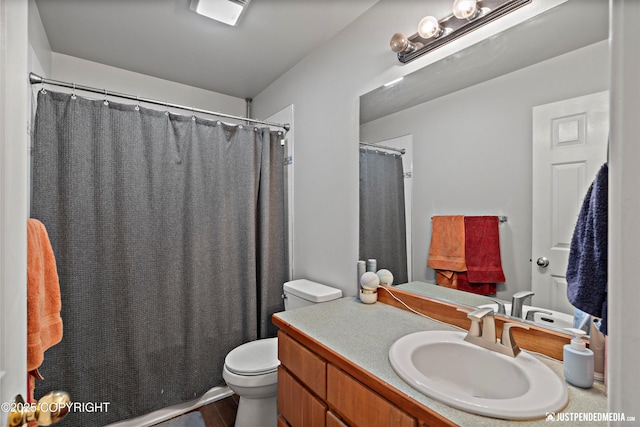 6801 E Tudor Rd, Anchorage, AK 99507 - bathroom featuring toilet, a shower with shower curtain, wood finished floors, and vanity