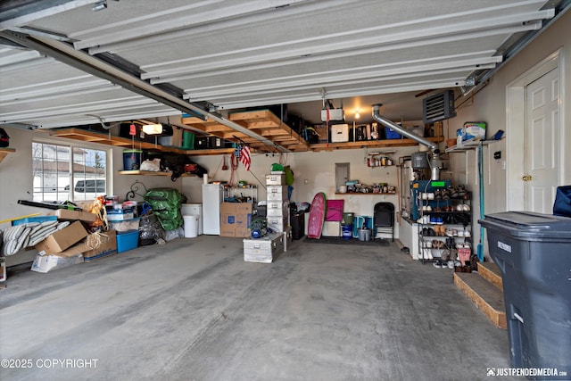 6801 E Tudor Rd, Anchorage, AK 99507 - garage featuring visible vents and a garage door opener