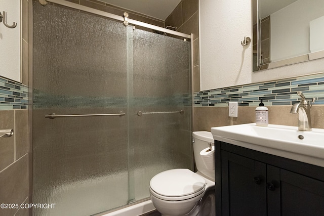 2808 W 29th Ave, Anchorage, AK 99517 - full bathroom with tile walls, toilet, vanity, a stall shower, and wainscoting