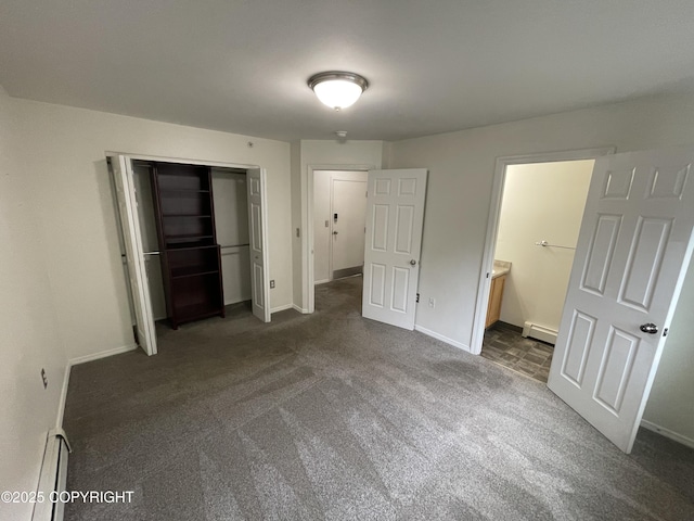 123 E 24th Ave # 4, Anchorage, AK 99503 - unfurnished bedroom featuring baseboard heating, dark colored carpet, and a closet