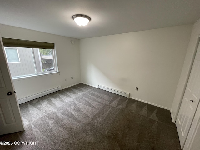 123 E 24th Ave # 4, Anchorage, AK 99503 - unfurnished room with a baseboard heating unit, a baseboard radiator, and dark carpet