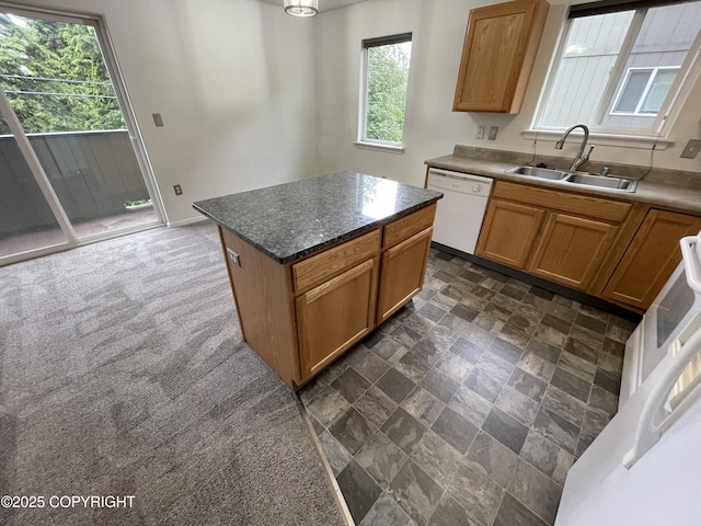 123 E 24th Ave # 4, Anchorage, AK 99503 - kitchen featuring white dishwasher, plenty of natural light, a kitchen island, and brown cabinetry