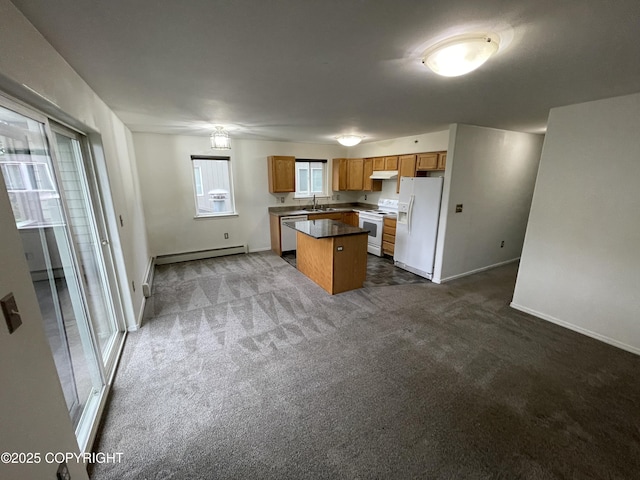 123 E 24th Ave # 4, Anchorage, AK 99503 - kitchen featuring white appliances, under cabinet range hood, dark colored carpet, and a kitchen island