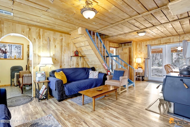13706 E First St, Talkeetna, AK 99676 - living room featuring wood ceiling, wood walls, stairs, wood finished floors, and arched walkways