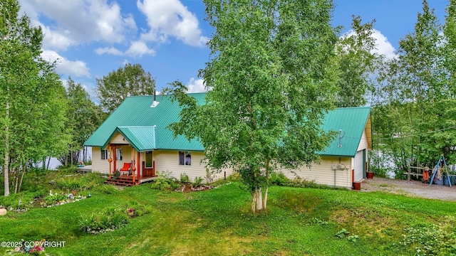 2643 S Rory Cir, Big Lake, AK 99654 - rustic home featuring driveway, a front lawn, metal roof, and a garage