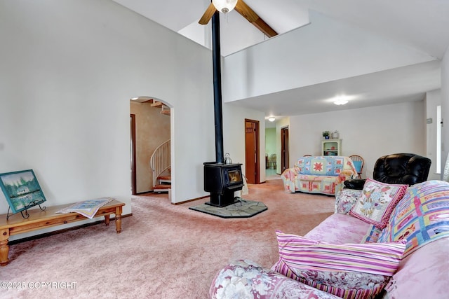 2643 S Rory Cir, Big Lake, AK 99654 - carpeted living area with a wood stove, a ceiling fan, high vaulted ceiling, arched walkways, and stairs