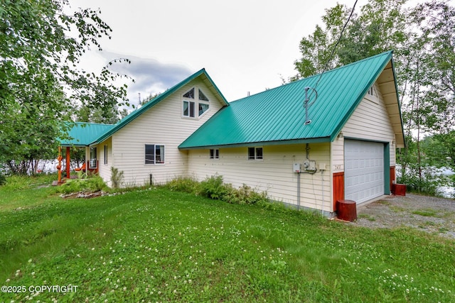 2643 S Rory Cir, Big Lake, AK 99654 - view of property exterior with metal roof, a lawn, and a garage