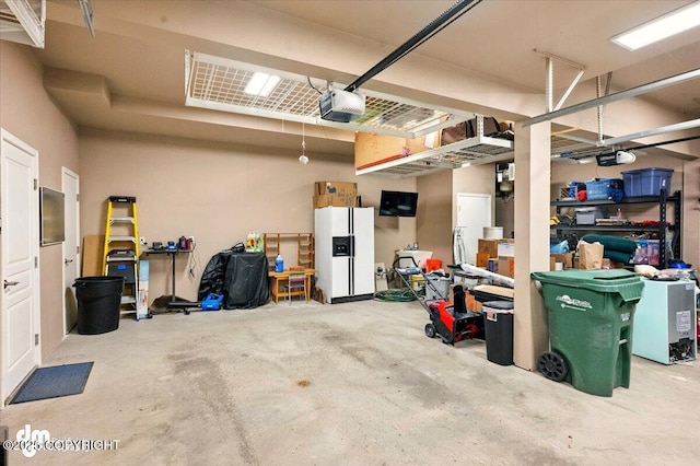 18627 Mountain Plover Cir, Anchorage, AK 99516 - garage with white fridge with ice dispenser and a garage door opener