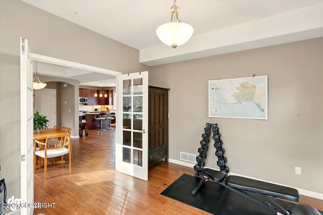 18627 Mountain Plover Cir, Anchorage, AK 99516 - workout room with wood finished floors and arched walkways