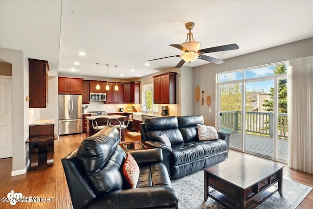 18627 Mountain Plover Cir, Anchorage, AK 99516 - living area with healthy amount of natural light, a ceiling fan, light wood-type flooring, and recessed lighting