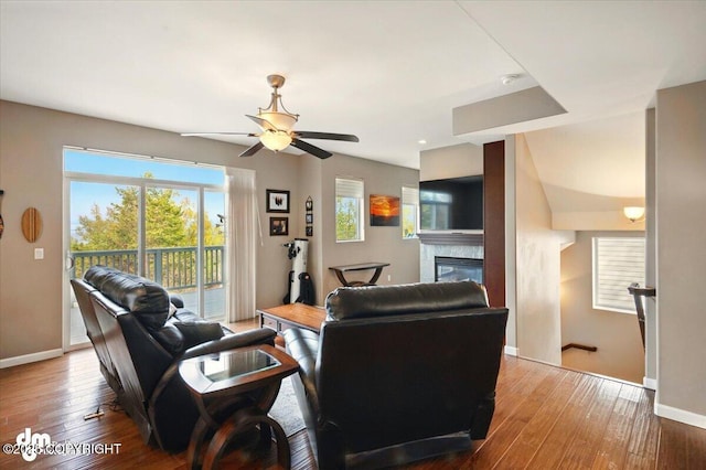 18627 Mountain Plover Cir, Anchorage, AK 99516 - living area featuring a glass covered fireplace, a ceiling fan, hardwood / wood-style flooring, and plenty of natural light