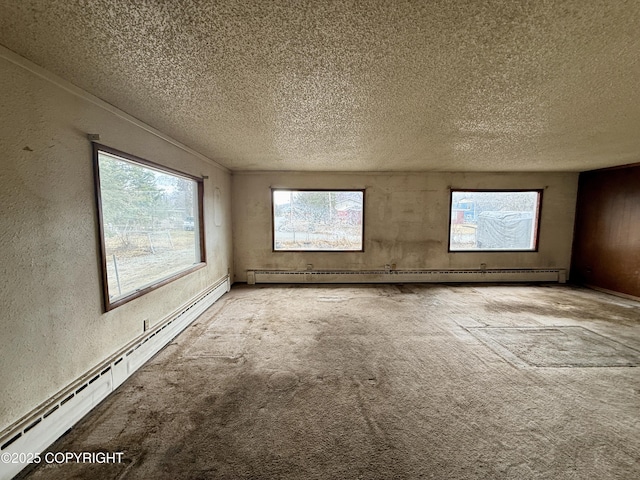 spare room with a baseboard radiator, a textured ceiling, a textured wall, and light colored carpet