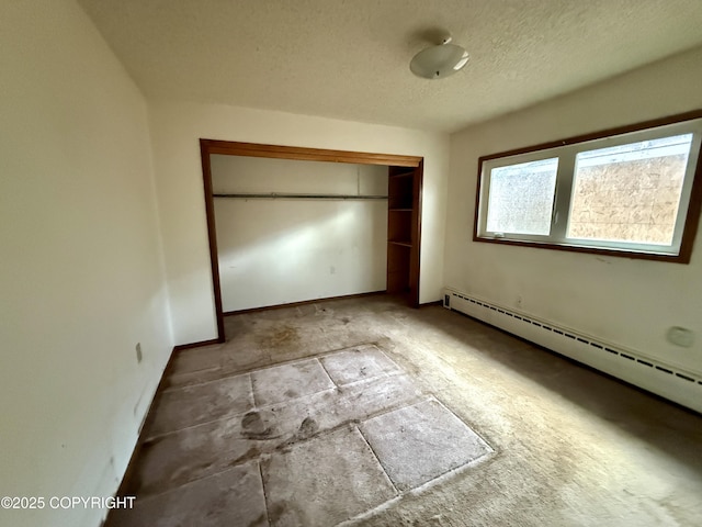 unfurnished bedroom with a baseboard radiator, a closet, a textured ceiling, and baseboards