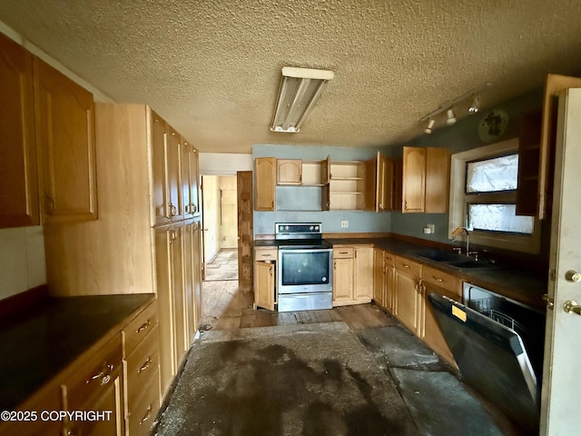 kitchen with electric range, a sink, dark countertops, a textured ceiling, and rail lighting