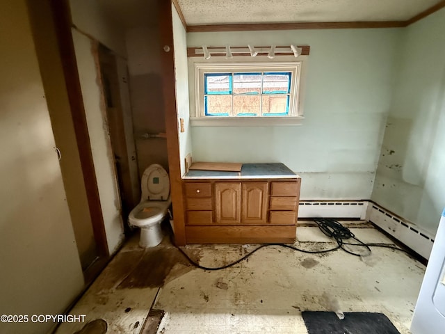 bathroom with toilet and a baseboard heating unit