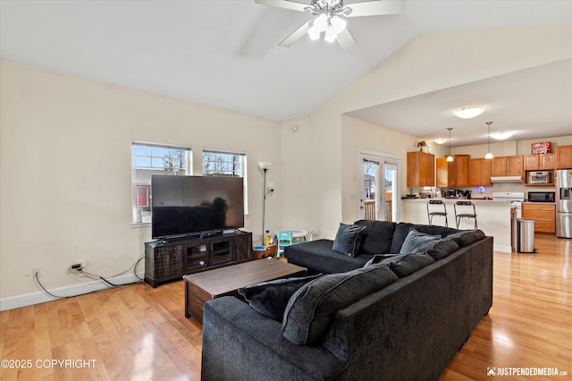 living room with light wood-style floors, a ceiling fan, and lofted ceiling