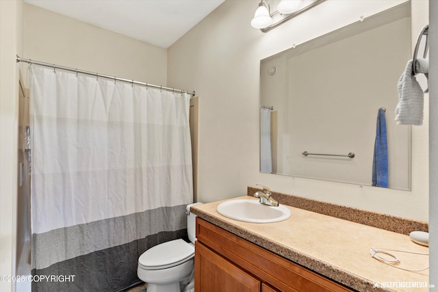 bathroom featuring vanity, toilet, and a shower with curtain