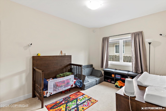 carpeted bedroom featuring baseboards