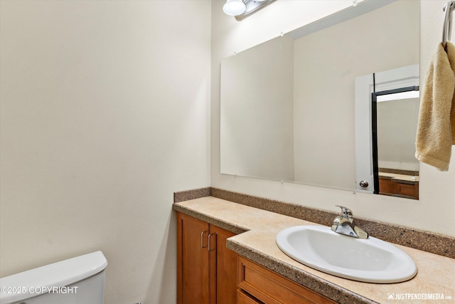 bathroom featuring toilet and vanity