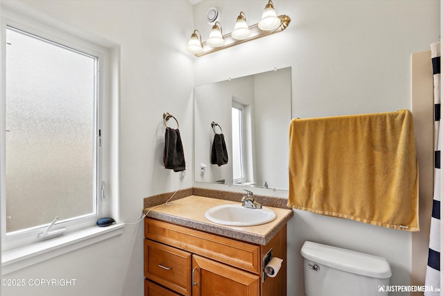 bathroom featuring vanity and toilet