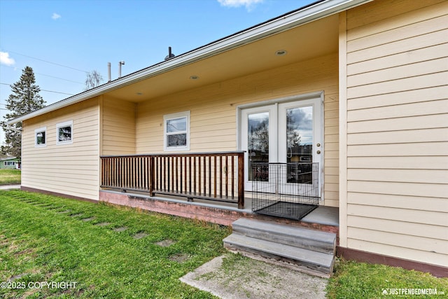 property entrance with a lawn