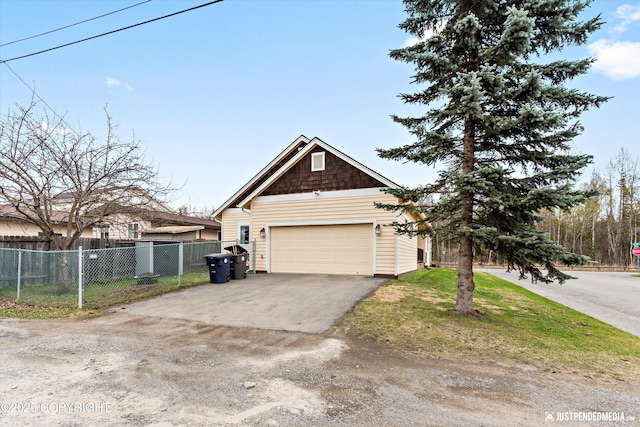 view of front of house featuring driveway, fence, and a garage