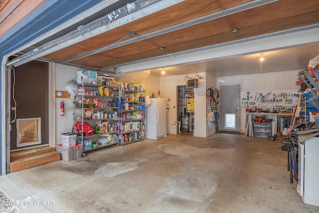 3585 Hoonah Dr, North Pole, AK 99705 - garage with freestanding refrigerator and a workshop area