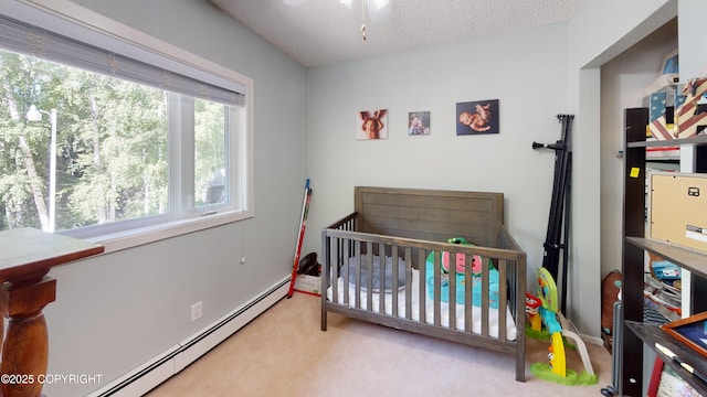 carpeted bedroom with a nursery area and baseboard heating