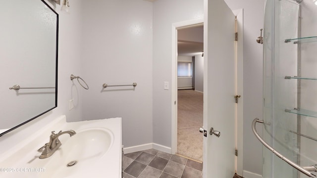 bathroom with vanity, tile patterned floors, a baseboard radiator, an enclosed shower, and baseboards