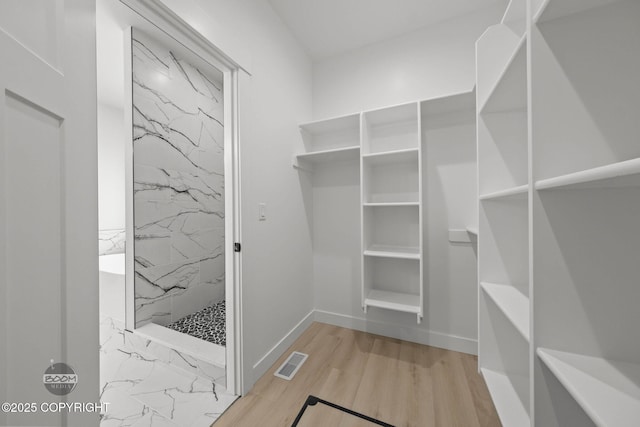spacious closet featuring wood finished floors