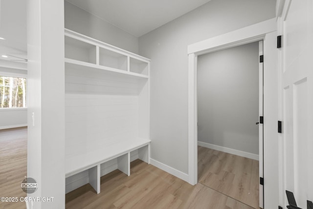 mudroom featuring wood finished floors and baseboards