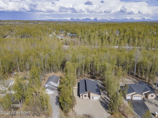 view from above of property with a heavily wooded area